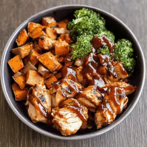 These BBQ Chicken and Roasted Sweet Potato Bowls are a perfect mix of flavors! Tender grilled chicken pairs wonderfully with sweet, roasted potatoes, all topped with a zesty BBQ sauce. Great for meal prep or a quick dinner. Save this healthy and delicious recipe to make any day of the week! Perfect for family dinners or casual gatherings.